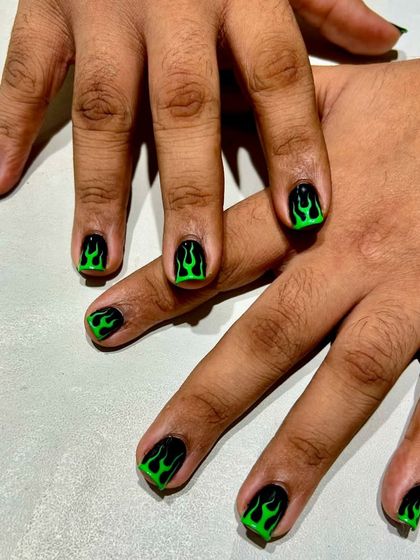 The full set of green flame nails. This look is all about confidence and attitude, proving that bold nail art is for everyone.