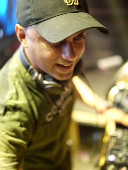 A candid shot of me smiling at the console at Sugar Factory. I genuinely love what I do, and it shows.