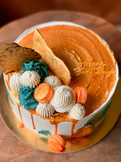 A different angle of the abstract caramel drip cake, showing the textures and colors.