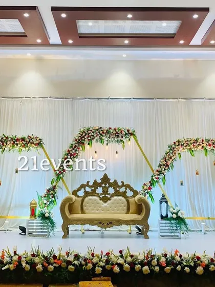 A perfect example of my modern engagement decor. This setup uses a geometric gold frame adorned with fresh flowers, creating a chic and stylish focal point for the couple.
