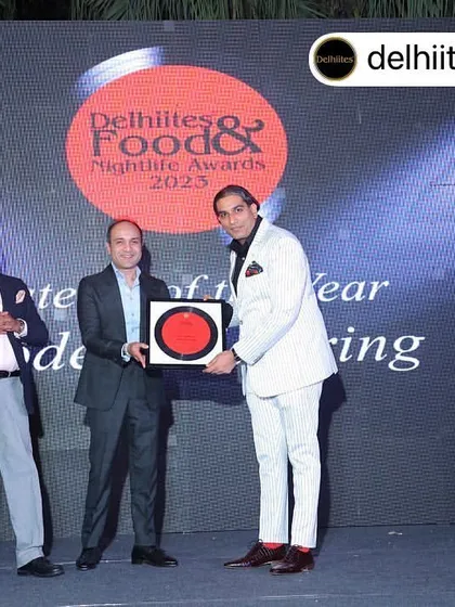 On stage receiving the 'Caterer of the Year' award at the Delhiites Food & Nightlife Awards 2023. A proud moment shared with industry leaders.