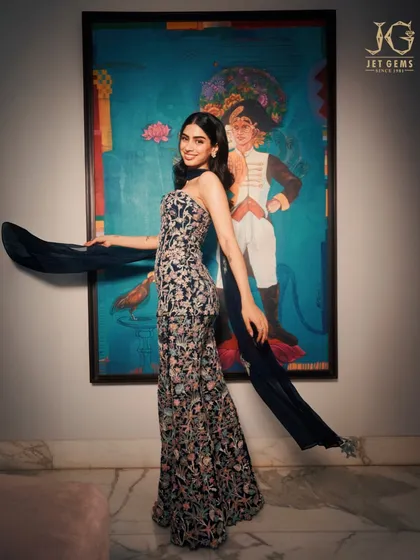 Art meets artistry. Khushi Kapoor poses against a beautiful painting, her own elegance a work of art, enhanced by the simple sparkle of my diamond earrings.