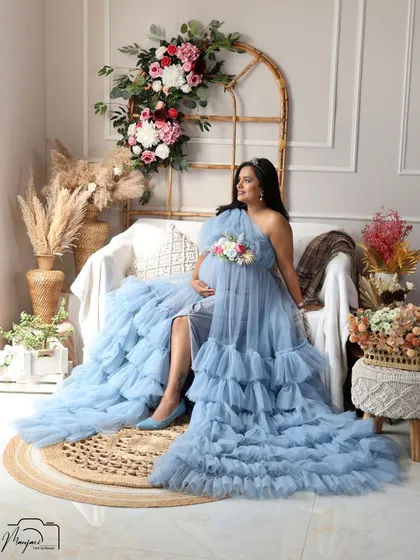 A stunning solo portrait in the blue ruffled gown. The layers of tulle and the soft color create a dreamy, ethereal look.
