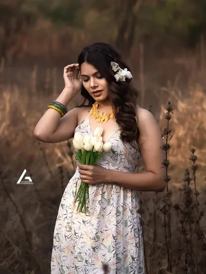 This image captures a quiet, introspective moment during an outdoor session. The way the model is interacting with the flowers and her hair feels natural and unstaged, which is a key part of my approach to lifestyle photography.