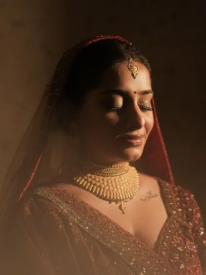 A quiet, beautiful moment captured by the photographer. This is the essence of my work: creating a look so perfect and personal that the bride feels completely at peace and radiant in her own skin, glowing in the golden light.