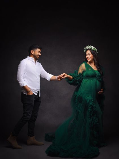 A playful and romantic couple's portrait. The husband-to-be takes his partner's hand as if asking for a dance.