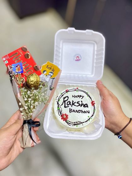 A complete Rakhi gift: our bento cake paired with a mini bouquet of chocolates and flowers.