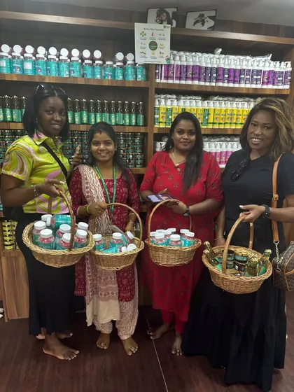 It's a joy to see customers from around the world visiting our store. Here, a group of happy shoppers holds baskets filled with our natural skincare and wellness products, ready to take a piece of Indian heritage home with them.