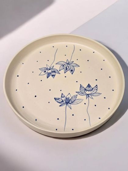 Inspired by the elegant beauty of the lotus flower, this sold hand-painted plate symbolizes purity and resilience. The delicate details bring a touch of nature's serenity to your table.