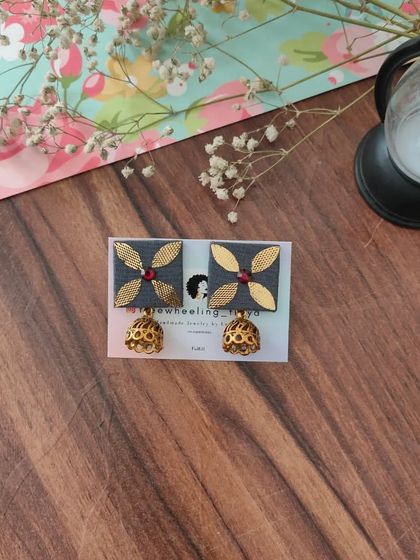 My gotapatti earrings are a festive favorite. These square fabric studs feature golden gotapatti work and a small jhumki drop, available in brown, green, and grey.