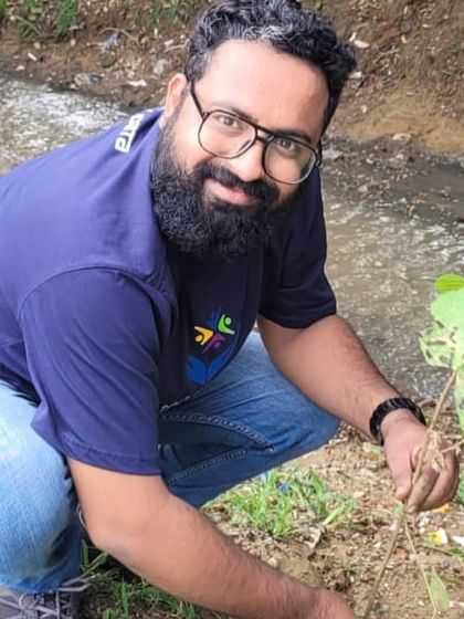 Another dedicated volunteer from NTT Data carefully plants a young tree, helping to strengthen the banks of Aravali Creek and improve its ecological function.