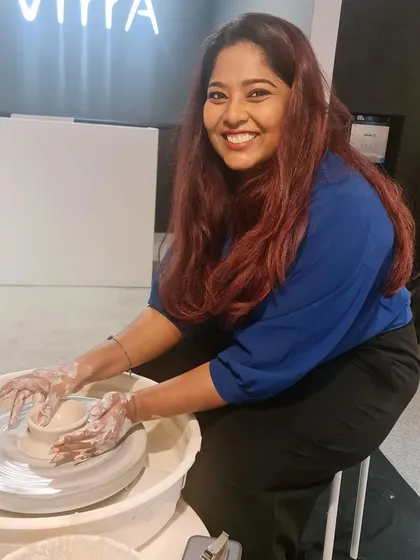 The joy of creating something with your own hands is universal. Here is a happy participant at the wheel during our Women's Day workshop, fully immersed in the pottery experience.