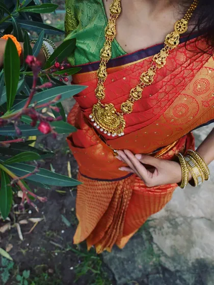 It's all in the details. A close-up of a perfectly draped Kanchipuram silk saree, showing how the pleats sit and the pallu falls. The right drape complements your jewelry and completes your entire look.