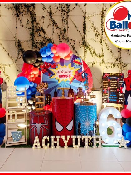 An action-packed Spider-Man-themed sixth birthday. The setup features multiple Spider-Man cutouts, a web-themed backdrop, and a large light-up number '6'.