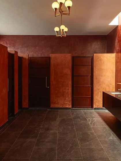 Even utilitarian spaces can be designed to deliver a powerful experience. For this event venue, I used a rich, monolithic color scheme, dramatic lighting, and symmetrical design in the restroom to create an unexpectedly artistic and memorable moment for guests.