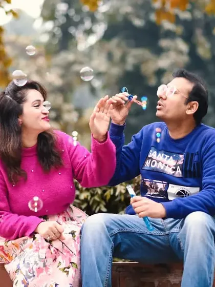 Celebrating a decade of love with a playful anniversary shoot. Moments like these, blowing bubbles in a park, are perfect for capturing the enduring joy and friendship in a relationship.