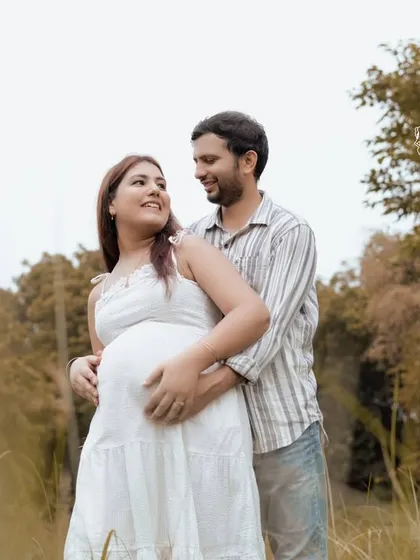 The couple shares a look of love and anticipation. These close-up shots during an outdoor session capture the deep connection between partners.