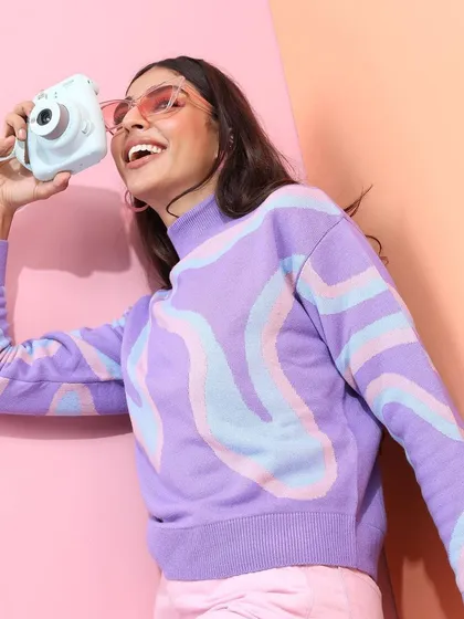 A cute and casual winter look. I styled this pastel swirl-patterned sweater with pink pants and a polaroid camera prop to create a playful, soft-girl aesthetic.