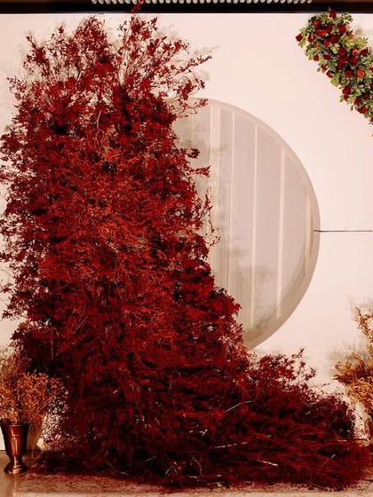 Another angle of the red foliage installation, showcasing its sculptural quality and the way it transforms the space.