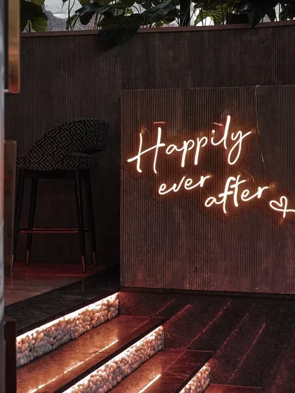 A "Happily ever after" neon sign sets the mood. It's these little details that contribute to the overall magic of the event.