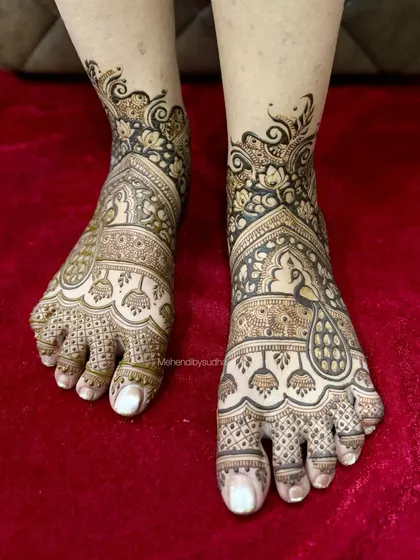 Bridal mehendi isn't just for the hands. I create beautiful, intricate designs for the feet that complement your full bridal look, ensuring you are adorned from head to toe. This design features classic peacock and jhumka motifs.