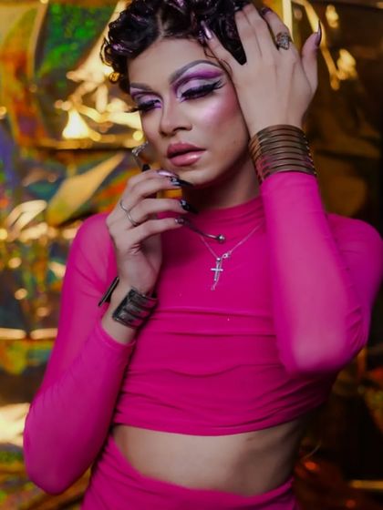 This shot highlights the glittery, textured hairstyle that completes the look.