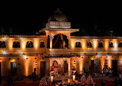 A palace facade lit up for an evening celebration, creating a warm and inviting golden glow. We use architectural lighting to highlight the beauty of historic venues.