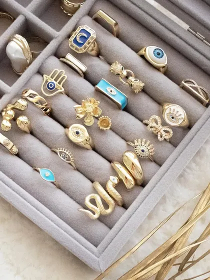 Build your ring stack. This image shows a tray full of my evil eye, hamsa, and other statement rings.