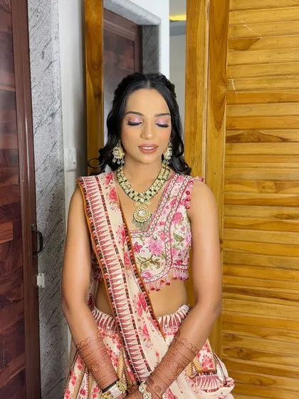 A close-up of her makeup, featuring a pop of pink on the eyes to match her lehenga.