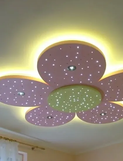 A lovely flower-shaped ceiling design perfect for a child's room. The petals are a soft pink, and the tiny integrated lights create a sparkling, starry effect.
