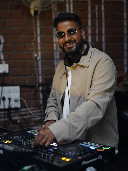A clear shot of me at the decks, focused and enjoying the moment. This shows my professional setup and my hands-on approach to live mixing, ensuring the music flows perfectly throughout your event.