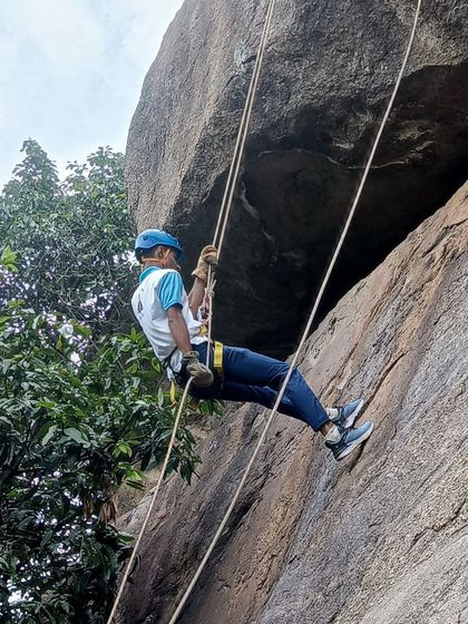 An Air Force participant practices his rappelling technique with proper form.