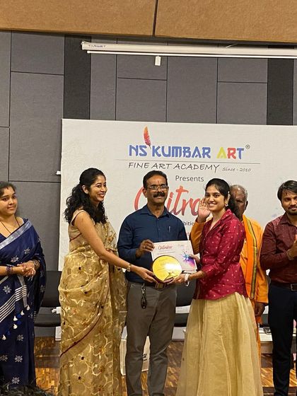 A moment of pride as our student receives her Chitrakar award on stage. We create these moments to honor the hard work and creativity of our artists.