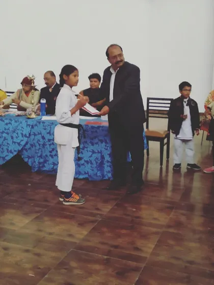 Our head instructor, Mr. Ramesh Bansal, awarding a gold medal to a young champion. We believe in recognizing and celebrating every student's hard-earned success.