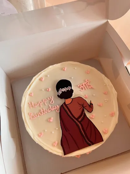 A beautiful and personal cake I made for an "Aai" (mom). It features a hand-drawn illustration of a woman in a saree, accented with a floral hairpiece and tiny hearts.