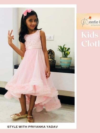 This pretty pink high-low dress is perfect for parties. The embroidered top and ruffled tulle skirt create a look that is both elegant and fun.