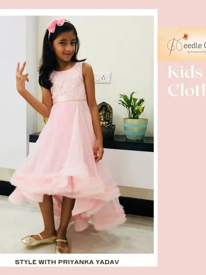 This elegant high-low gown in baby pink is perfect for a young girl attending a wedding or formal party. The dress features a detailed bodice and a ruffled hemline that adds a touch of sophisticated fun. Image 40 shows the dress in motion.
