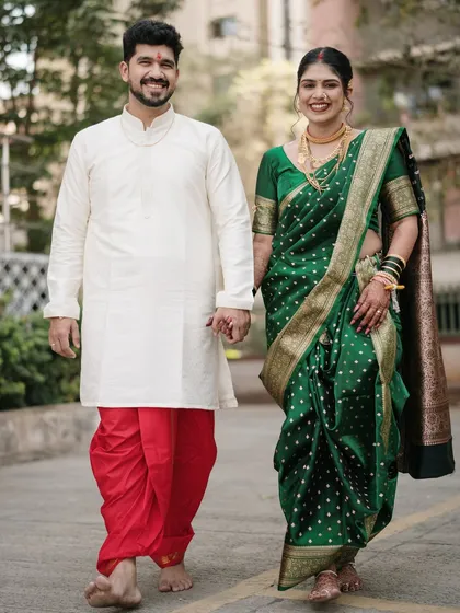 Walking into their future together. This full-length shot captures the elegance of their traditional Marathi attire and the joy of their first steps as a married couple.