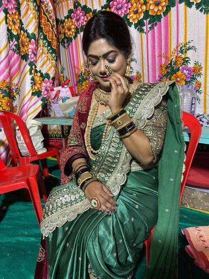 This designer green Nauvari with a velvet shawl is a royal look for a bride. The heavy jewellery completes the ensemble perfectly.