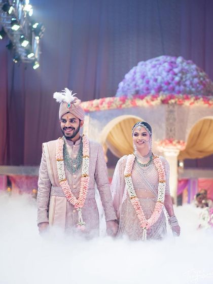 A grand entrance for a stunning couple. Hemangini's makeup was designed to look flawless on stage and in photos.