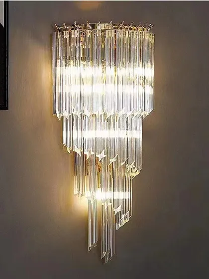 A crystal wall sconce with a cascading design. This fixture matches some of our grand chandeliers for a coordinated, luxurious look.