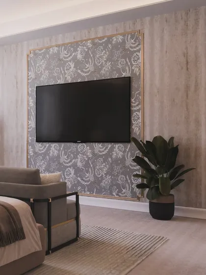 The TV is elegantly framed by patterned wallpaper, integrating it into the classic decor of the room.