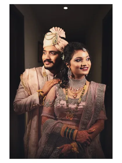 A stunning portrait of the couple on their wedding day, showcasing their elegant outfits and happy smiles.