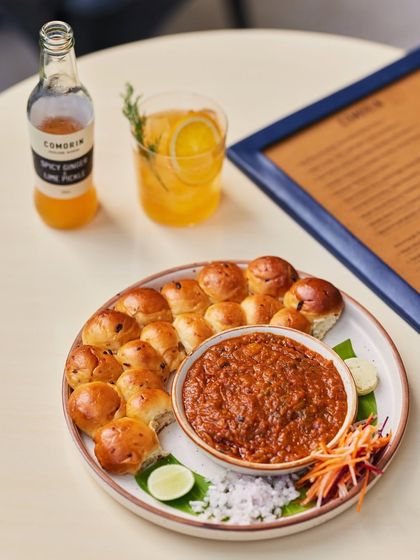 The perfect pairing: our flavorful Pav Bhaji served alongside one of our house-made sodas. This combination offers a refreshing and satisfying taste of modern Indian comfort food.