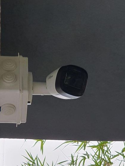 A neatly installed Dahua bullet camera with a junction box to protect the wiring from weather and tampering.
