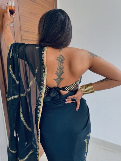 The back of our black and gold striped halter blouse, as seen on a client. The tie-up detail allows for a comfortable and adjustable fit.