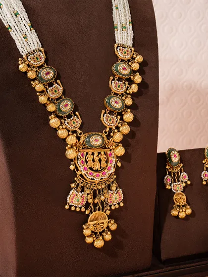 We present the Rajnitya Haar, a woven anthem of gold and tradition. This ceremonial treasure features divine motifs and intricate nakashi work, strung with lustrous pearls, embodying generational pride. It is a bridal companion designed not just for a wedding, but for a lifetime of legacy.