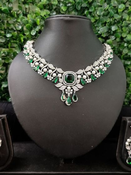 A complete view of another emerald and diamond look set, this one featuring a choker style with pearl accents.