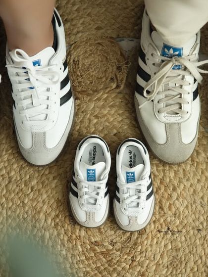 An adorable top-down shot of the parents' and baby's matching shoes. This unique photo is a playful and memorable part of any maternity session.
