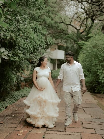 A romantic walk in the park. This ivory white ruffled gown is perfect for a soft, elegant, and timeless maternity or pre-wedding photoshoot.